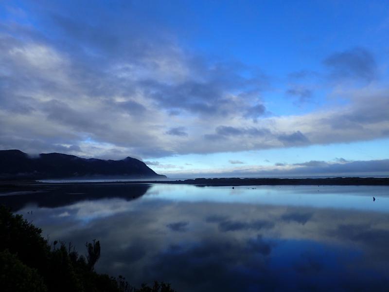 reflection in a lagoon of the sky and hills