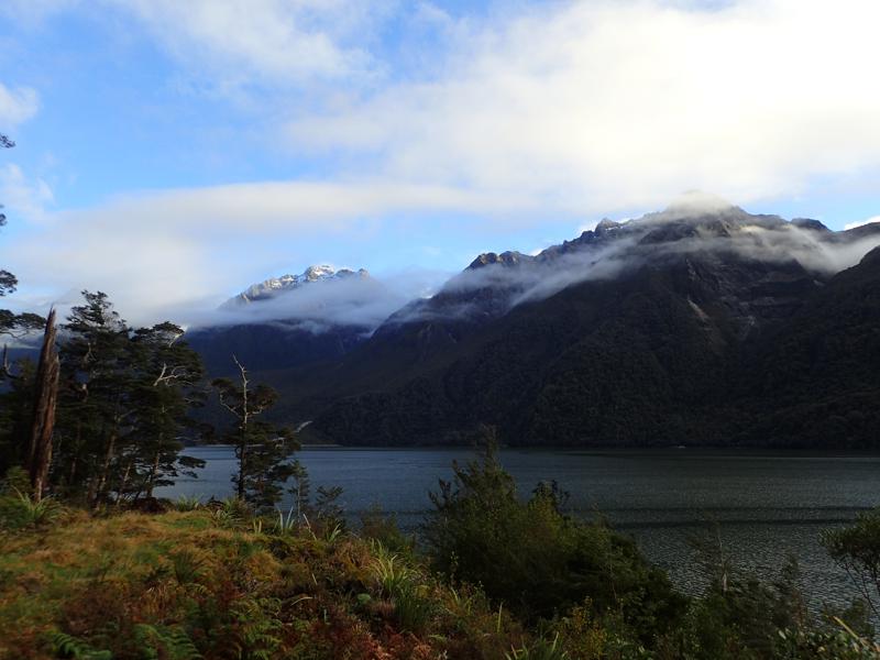 lake with mountains and blue sky behind