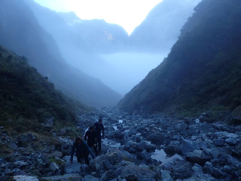 a narrow valley and cloud in valley bottom far below