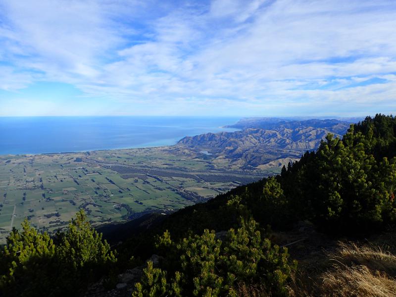 views from the summit of farmland, hills and the ocean beyond