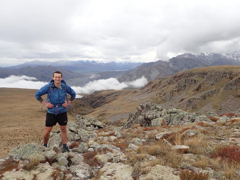 a person at the top of a mountain valley