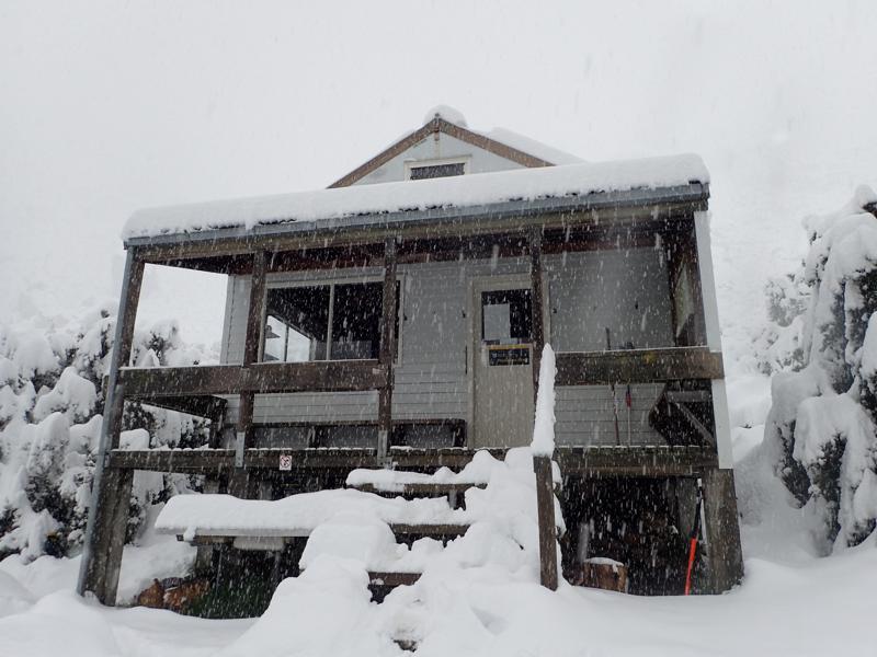 a snow covered backcountry hut