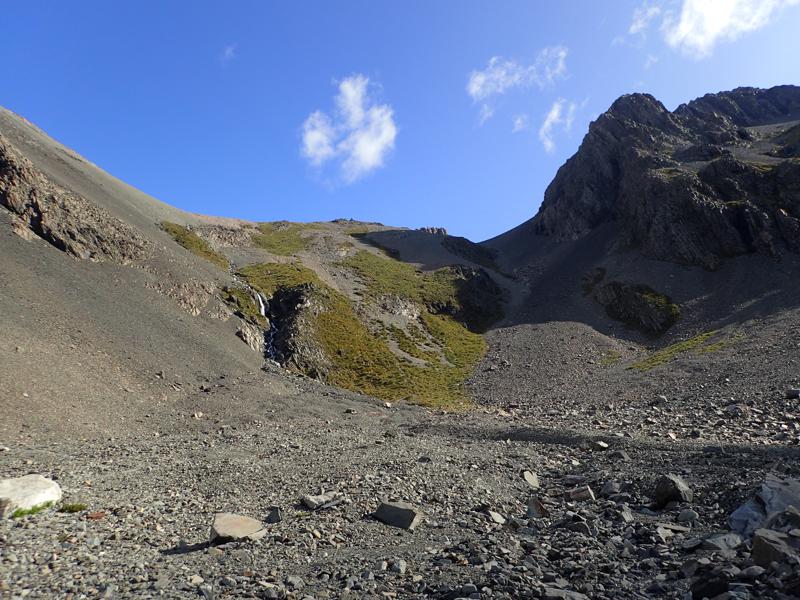 looking up at a scree slope with grassy patches