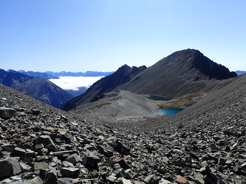 2 small lakes with scree slopes and mountains all around