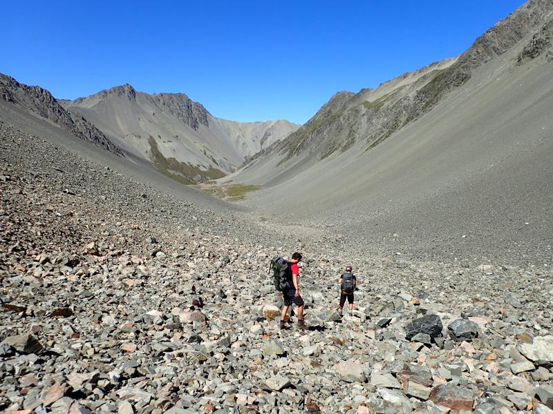 2 hikers descending a rocky valley