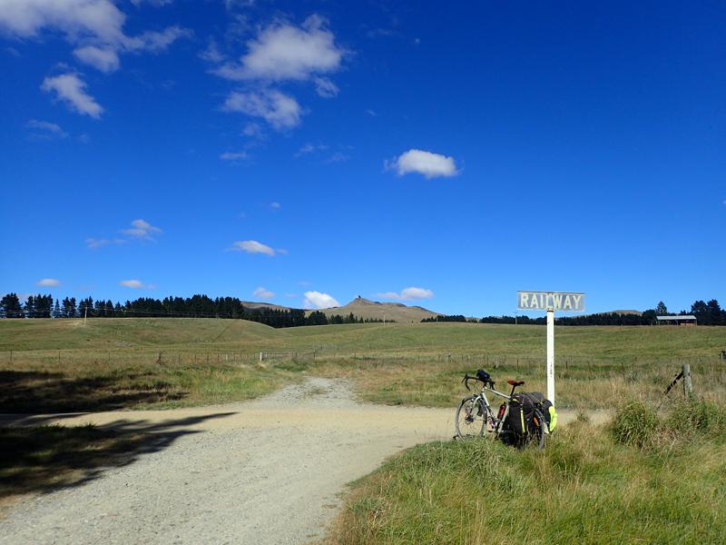Bike beside railway sign and junction with blue sky