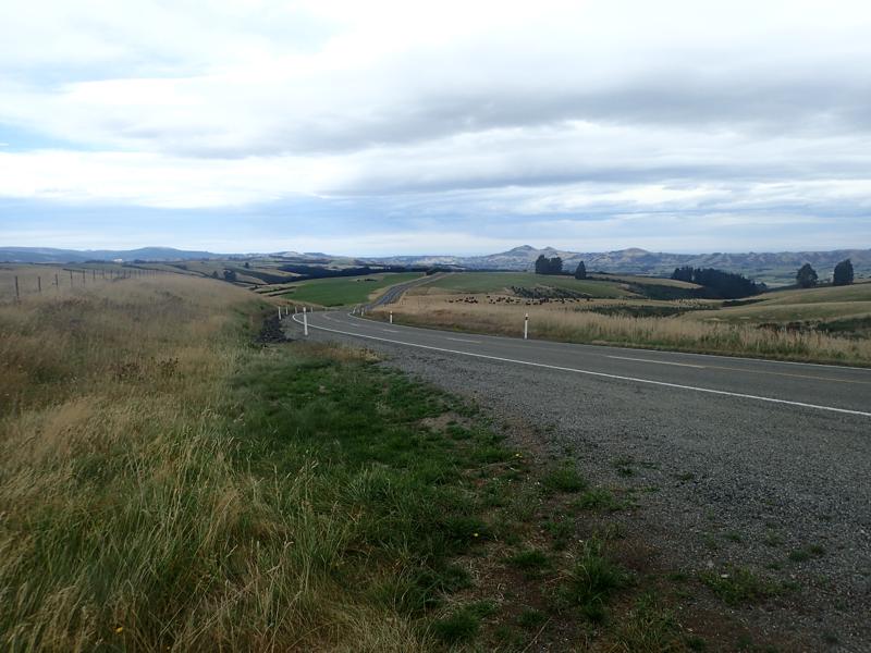 Highway stretching into distance over undulating hills