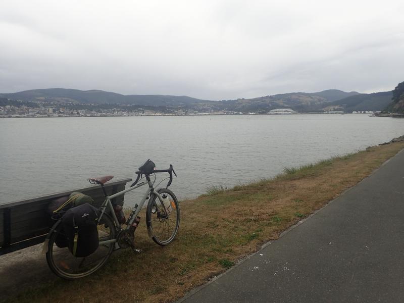 Bike beside harbour with hills beyond