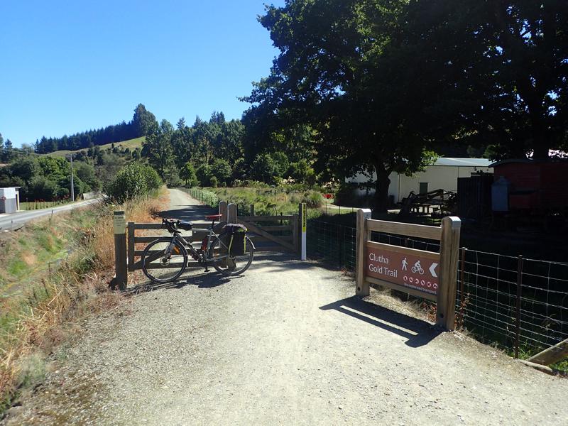 Bike resting against a gate on a gravel cycleway